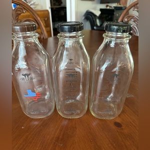 Three glass quart milk containers